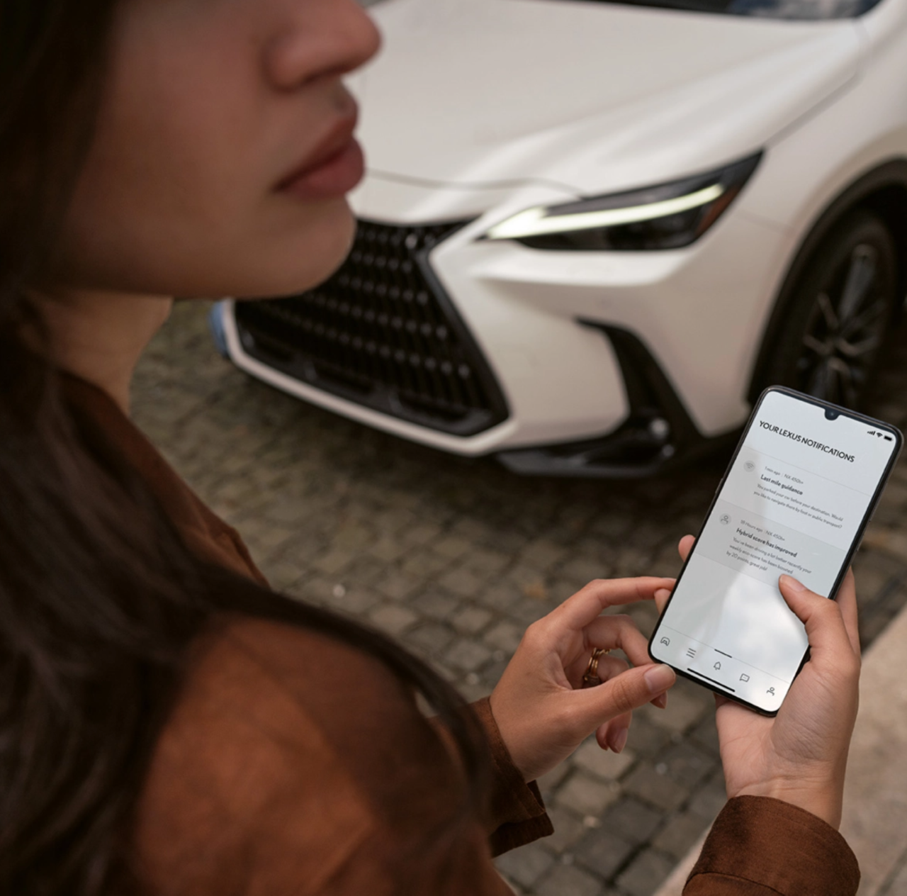Woman on phone looking at Lexus Link+ app
