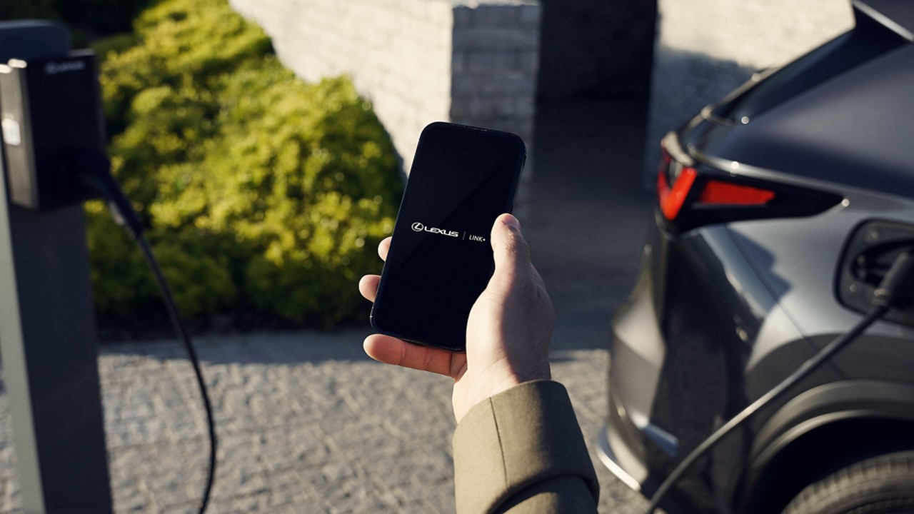 A person using a mobile phone to access the Lexus Link+ app